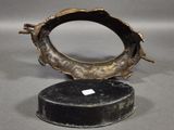 a bronze sculpture of a fish on a black base