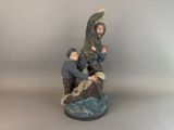 figurine of a statue of a man on a boat with two children