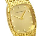 a close up of a gold watch on a white background