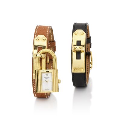 an image of a couple of wrist watches sitting next to each other