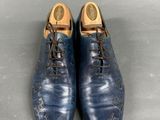 pair of blue leather shoes with laces on the toes