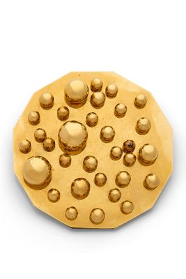 a gold cookie that has a lot of bubbles on it
