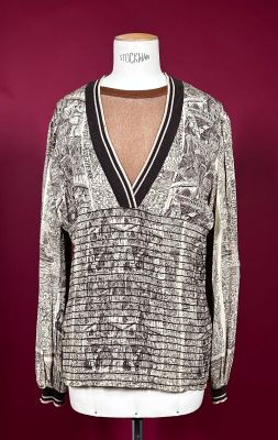 an image of a woman ' s sweater on a mannequin stand