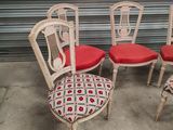 four chairs with red cushions are sitting in front of a garage door