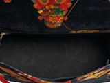 a black purse with a floral design on it