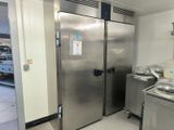a large stainless steel refrigerator in a kitchen next to a sink