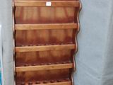 a wooden shelf that has a bunch of books on it