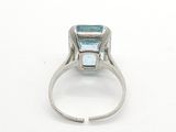 an image of a ring with a blue topaz stone in it