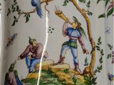 a picture of a vase with a bird and a man on it