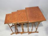three tables with wooden tops sit on a white surface
