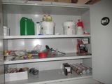 a cabinet with many items on it in the kitchen