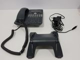 a telephone and a charger sitting on a table