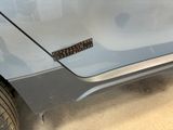 a close up of a car door with a sticker on it