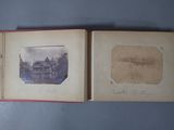 an old photo of a book opened to show a picture of a house