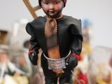 a figurine of a man with a cross on top of a table
