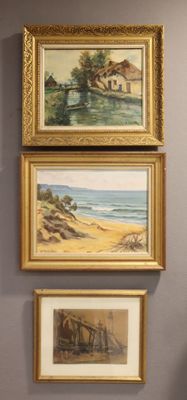 paintings on the wall of a room with a chair and a vase