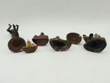 a group of five bronze figurines of various shapes and sizes