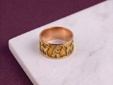 an image of a gold ring on a marble surface