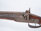 a close up of a gun with a wooden handle on a white background