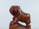 a statue of a lion on a rock on a table
