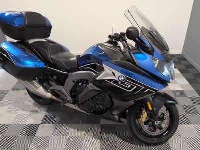 a picture of a blue and black motorcycle parked on a checkered floor