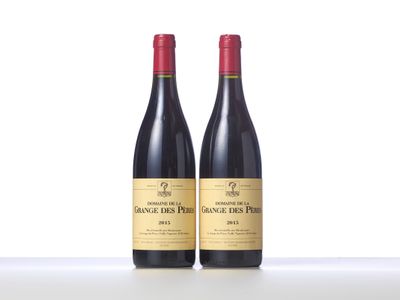 two bottles of red wine sitting on top of a table