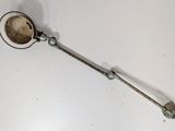 a metal spoon with a metal handle on a white surface
