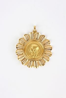 a close up of a gold medal on a white surface