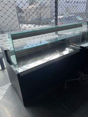 a glass display case with a lot of food inside of it