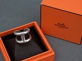an orange box with a silver ring inside of it on a table