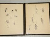 two framed drawings of people on the wall