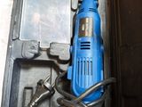 a blue electric drill sitting in a black case