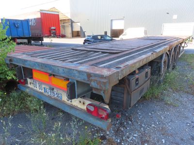 un gros camion à plateau garé sur un parking