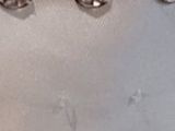 a lot of silver buttons on a white surface