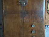 a wooden cabinet with a clock on the top of it