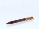 a close up of a pen sitting on top of a white surface