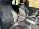 two seats in the back of a car with a cup holder