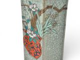 a vase with a bird and flowers on it
