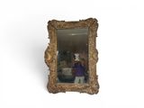 a woman taking a picture of herself in a mirror