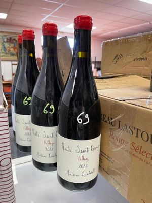 several bottles of wine sit on a table in a store