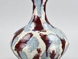 an image of a vase with a red and blue design
