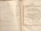 an open book with a map on it sitting on a table