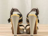 a close up of a pair of high heeled shoes on a wooden table