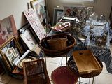 a table with baskets and pictures on it in a room