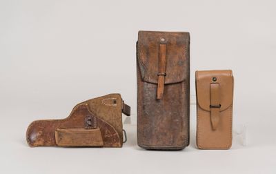 three pieces of leather are sitting on a table next to each other