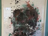 painting on the wall of a living room with a painting of a skull on it