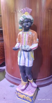 a statue of a boy standing on a box