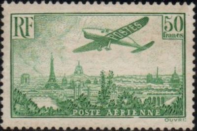 an old stamp with a picture of a plane flying over a city