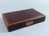 a small brown box with a gold trim around it