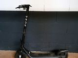 a scooter that is leaning against a wall